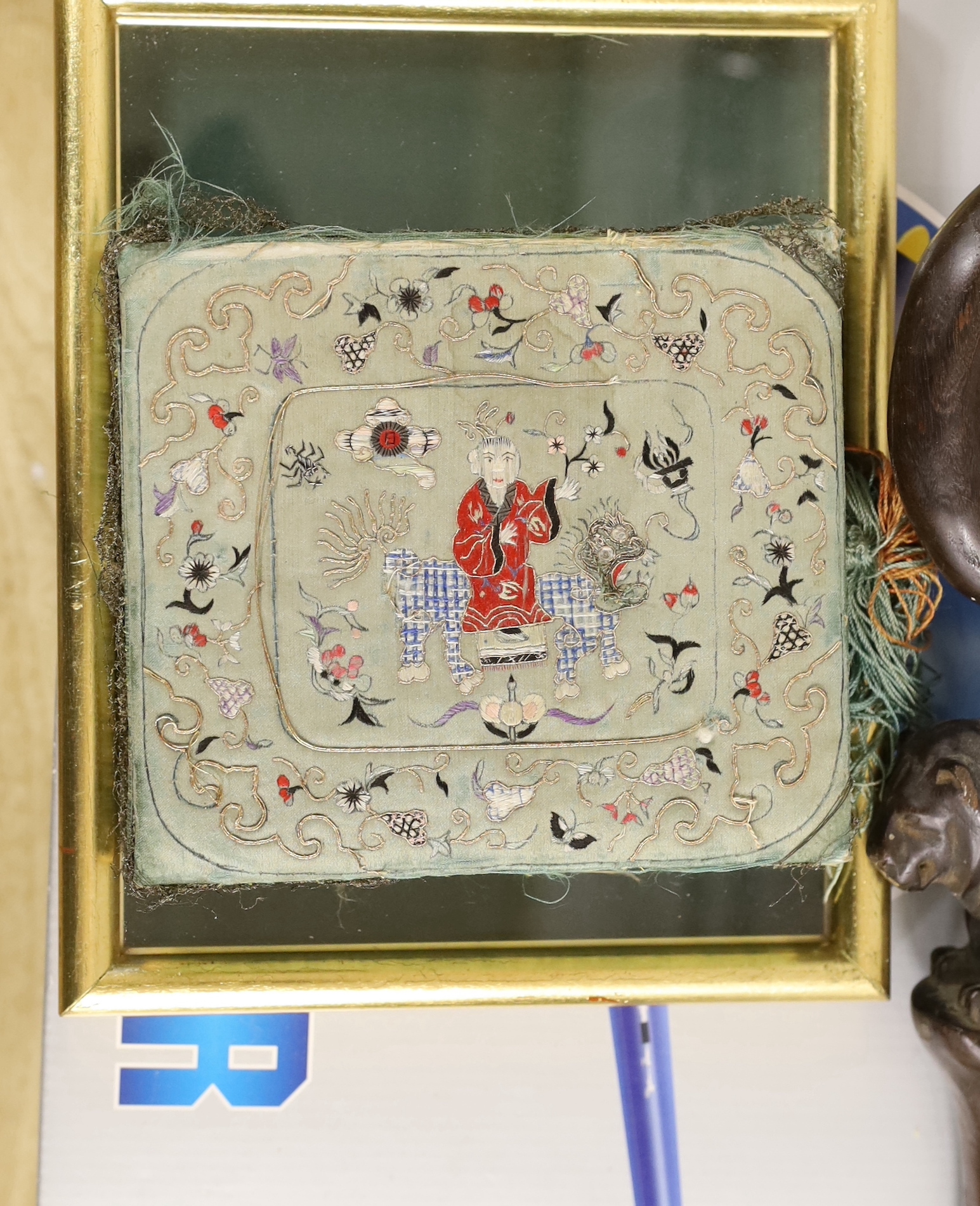 Six items, including an embroidered cap, embroidered box, framed gilt finals, a carved walking stick, a money box, and a diecast military aircraft